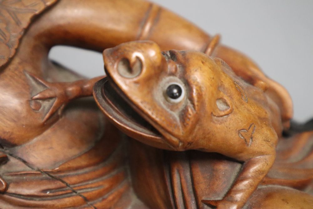 A Chinese hardwood group of Liu Hai and his three legged toad, early 20th century, together with an ebonised wood stand, length 36cm